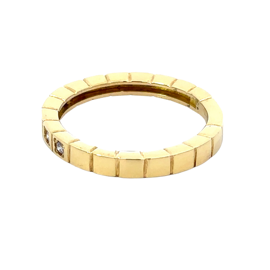 Close-up of white stone in 18k gold ring