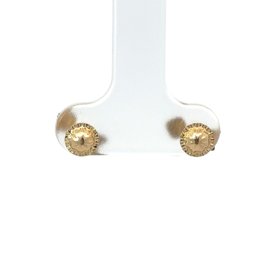 Baby wearing 18k gold arrow stud earrings
