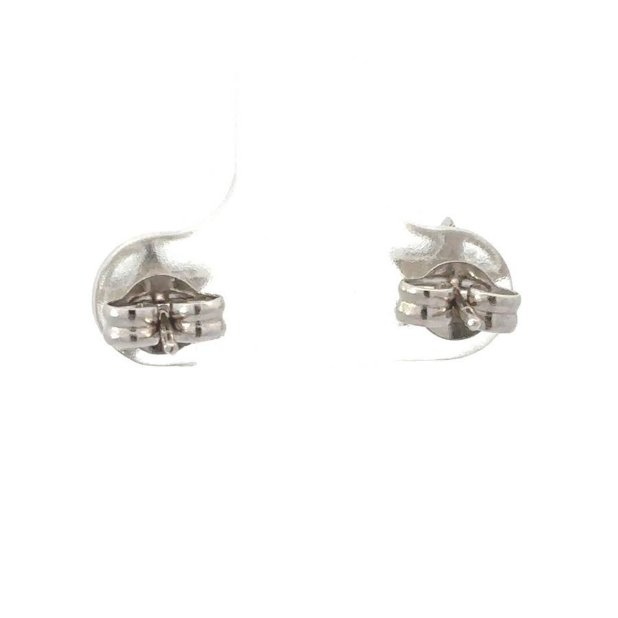 Elegant woman wearing 18k gold diamond star earrings