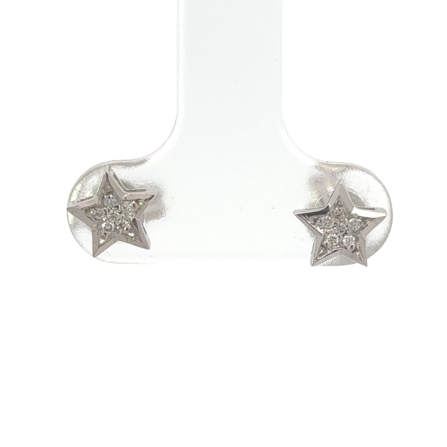 Close-up of 18k gold star stud earrings with diamond center for women