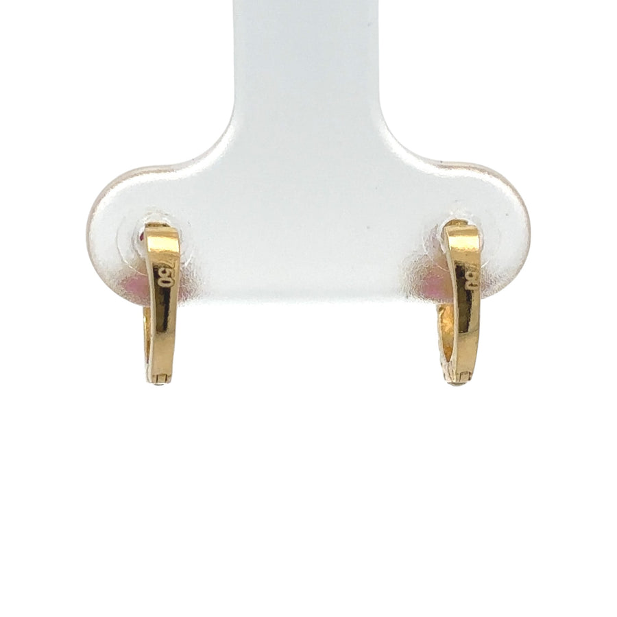 Petite gold earrings styled on baby ears