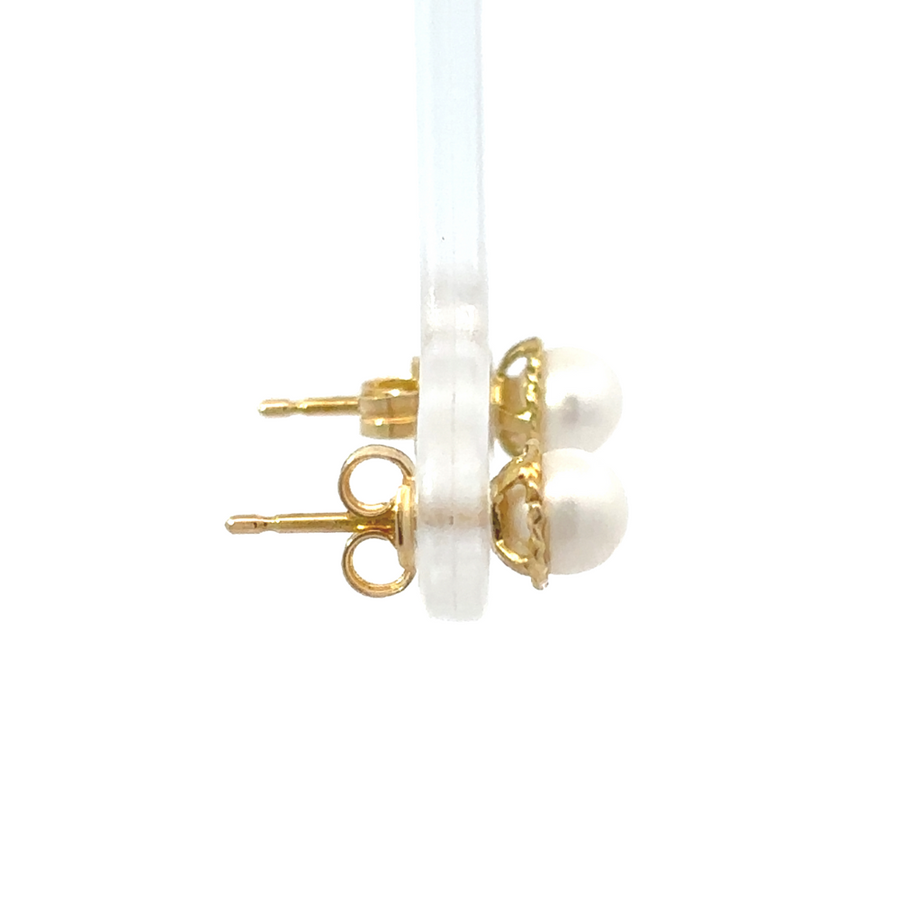 Side view of 18k gold stud earrings showing their sleek and simple design