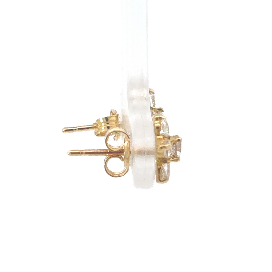 Baby girl wearing 18k gold flower stud earrings