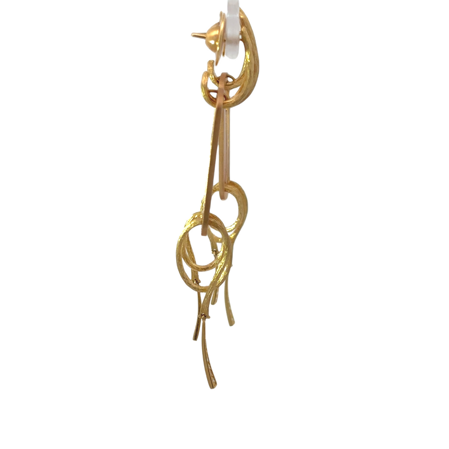 Close-up of dual-tone gold earrings featuring diamonds