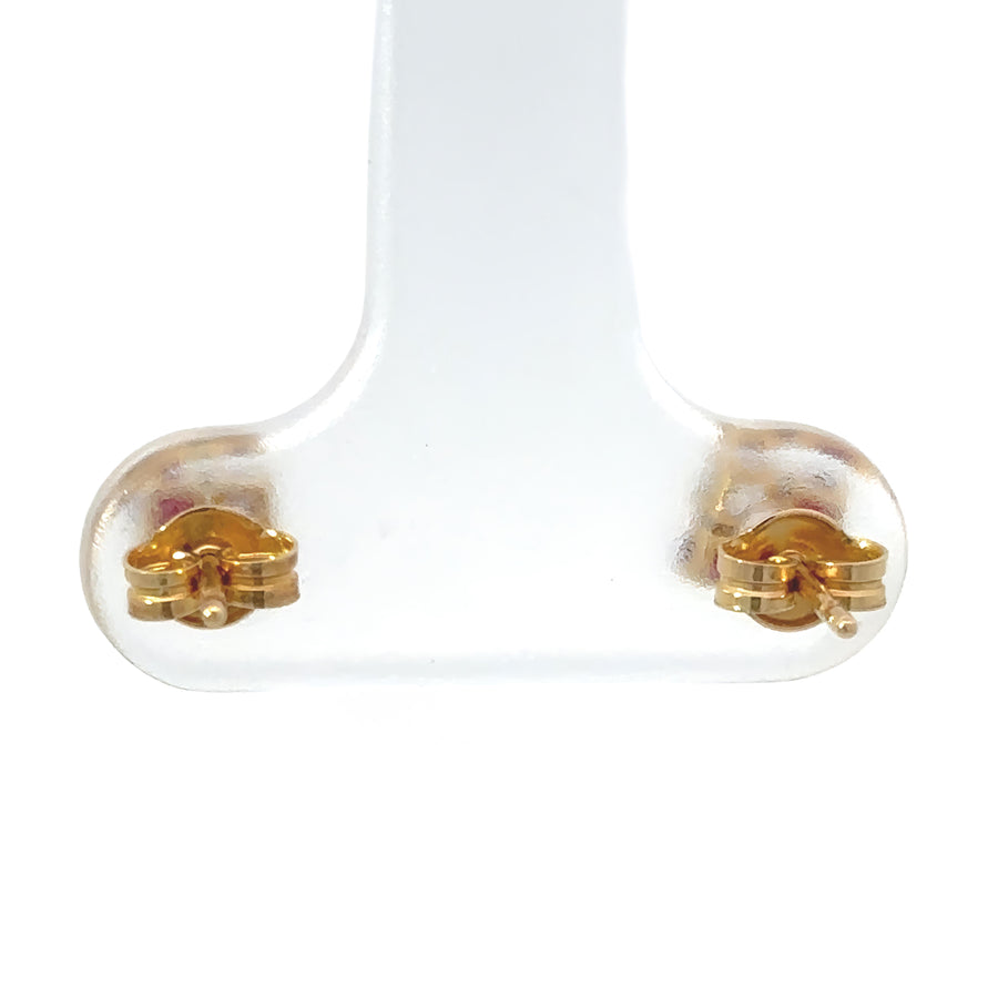 Baby wearing 18k gold stud earrings for sensitive ears