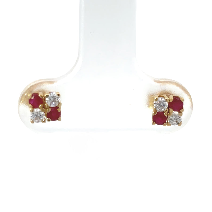 Close-up of 18k solid gold baby earrings on white background