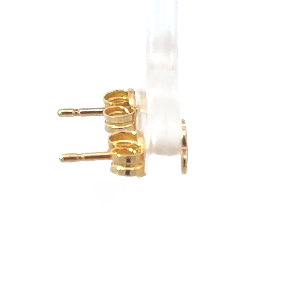 Close-up of 18k gold baby earrings with dual heart motif