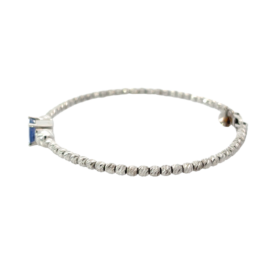 Close-up of sapphire set in white gold bracelet
