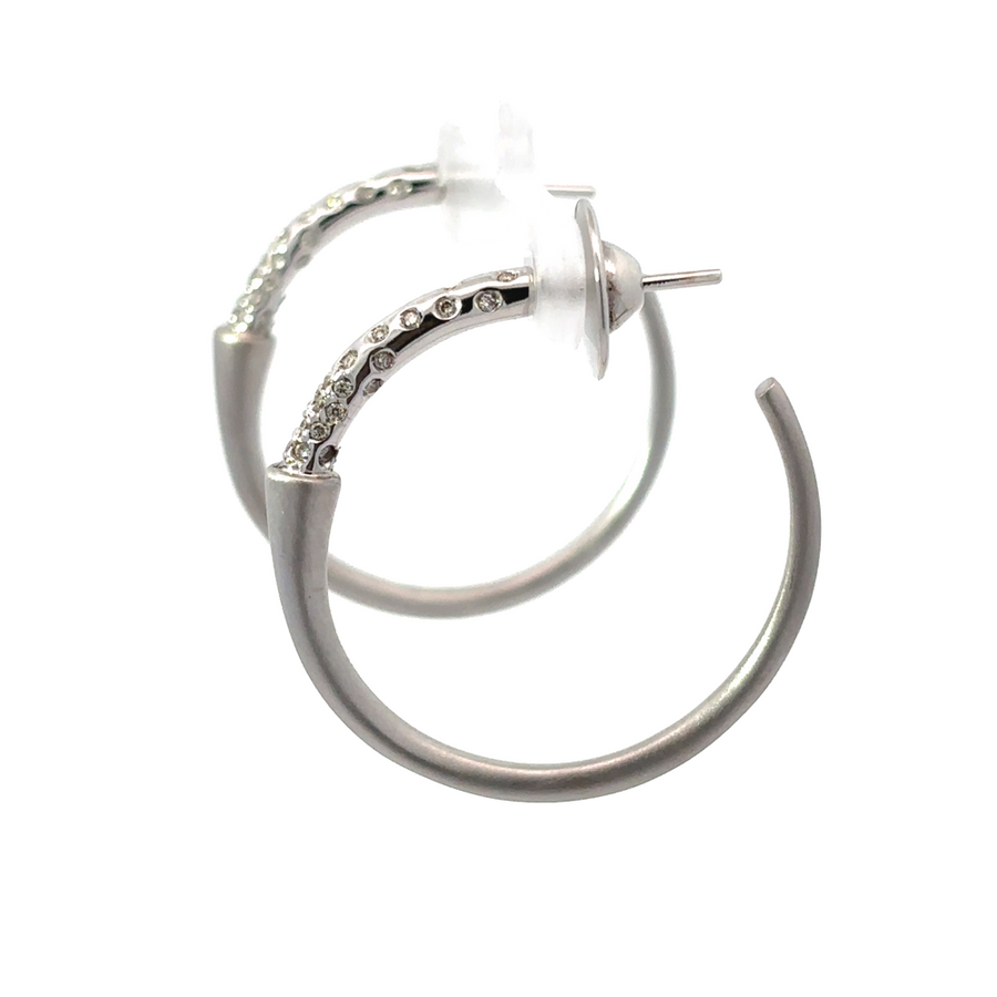 Side view of white gold diamond hoop earrings