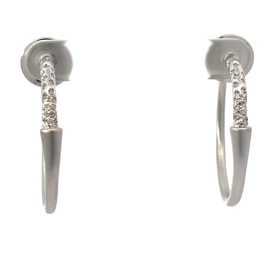 Close-up of 18k white gold hoop earrings with diamonds