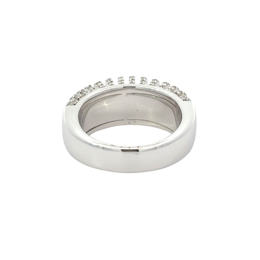 Flat-lay of 18k white gold ring with onyx center and diamonds on a soft fabric surface