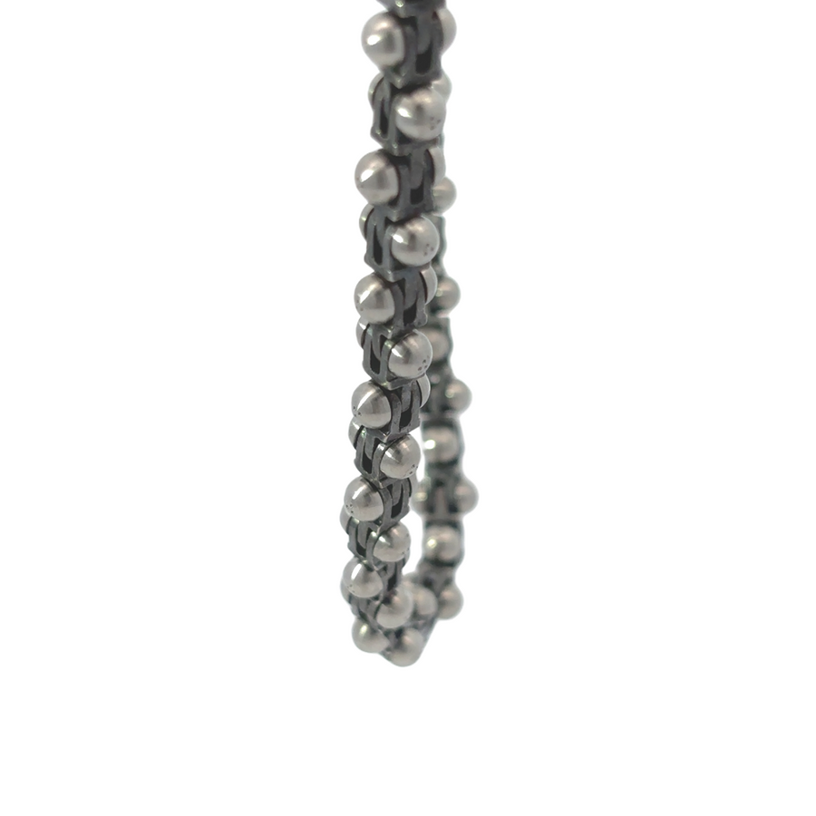 Close-up of 0.02-carat diamond embedded in carbon steel necklace