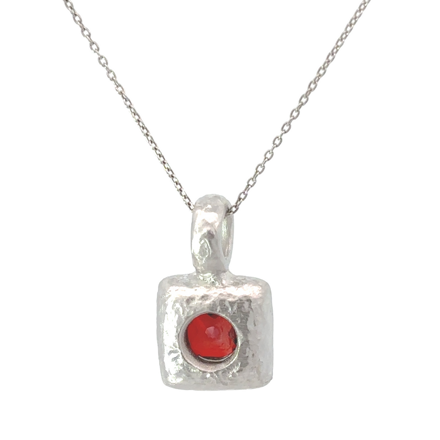 Three-piece silver jewelry set laid flat