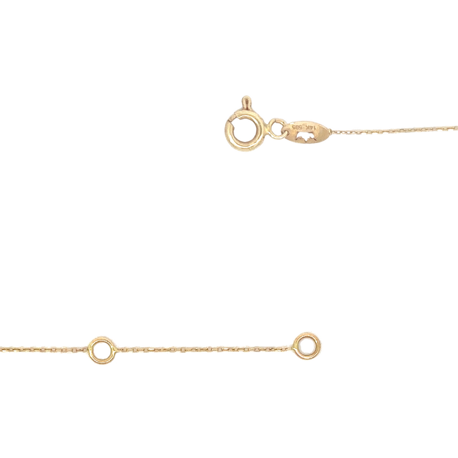 Necklace layered with other gold chains for a chic look