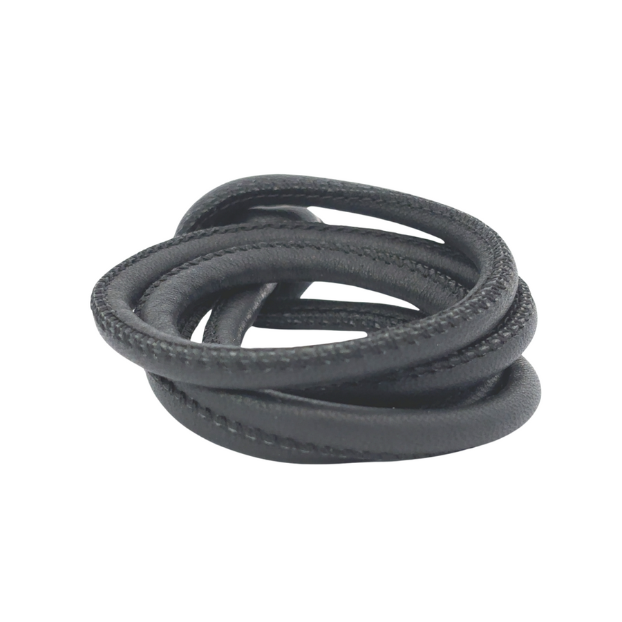 Unisex black leather bracelet displayed on neutral background