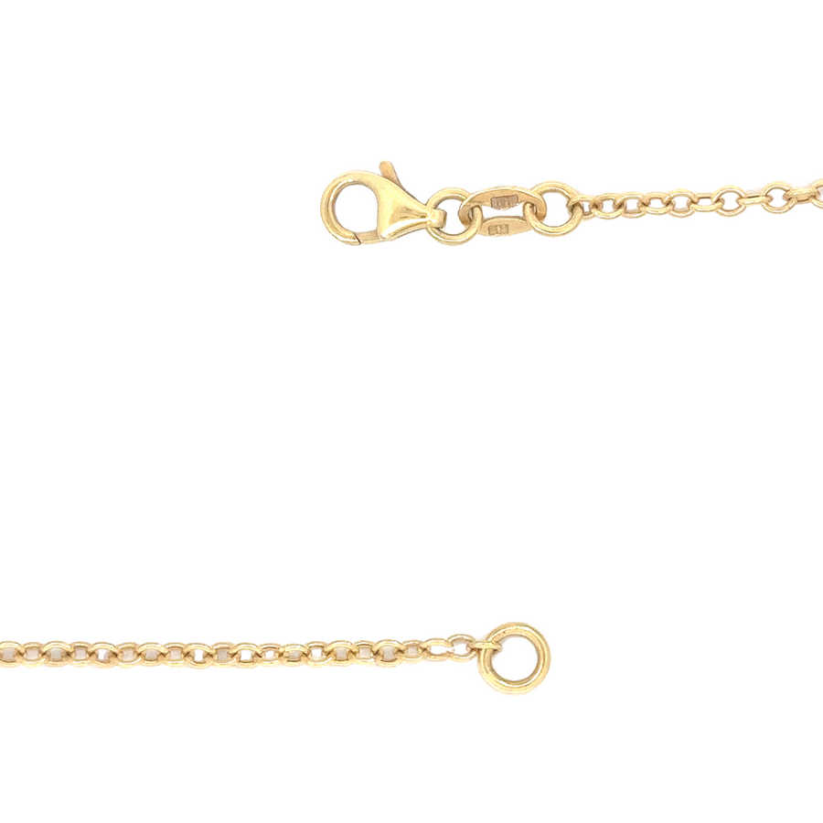 Flat-lay of 14k gold necklace on a marble surface, emphasizing its timeless design
