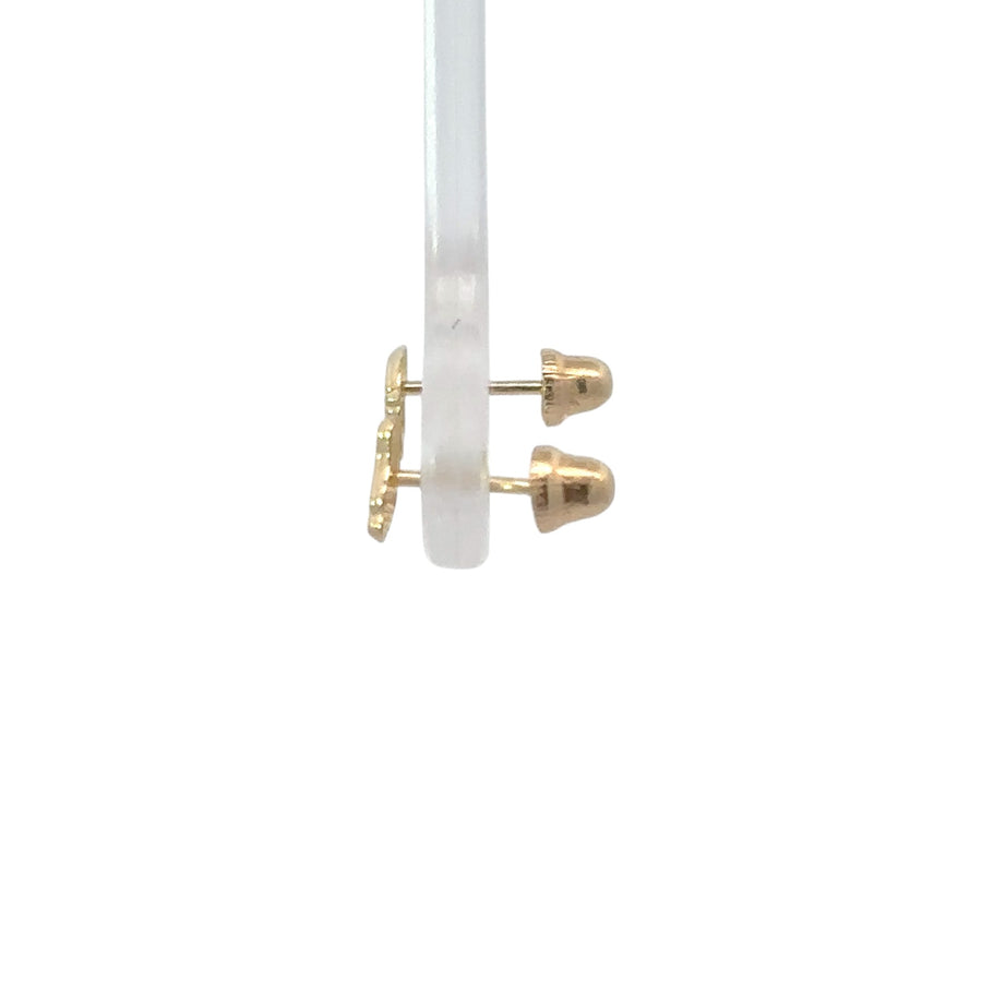 Pair of extra-extra-small 14k gold baby earrings on white background
