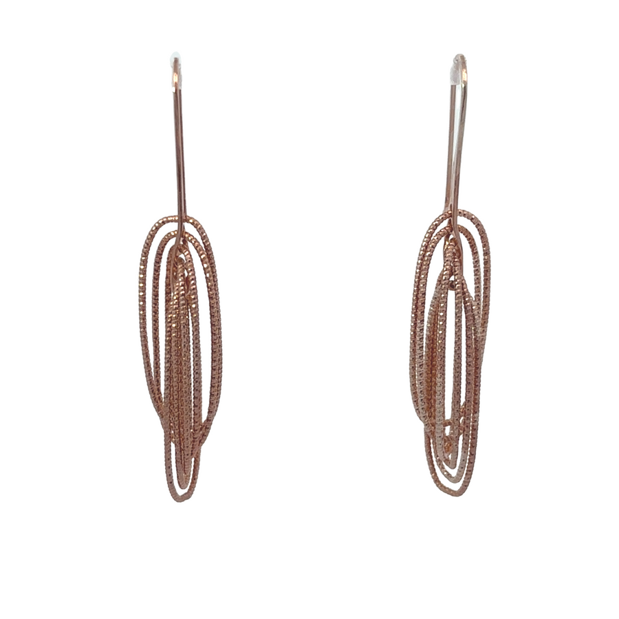 Diamond-cut oval silver earrings on white background