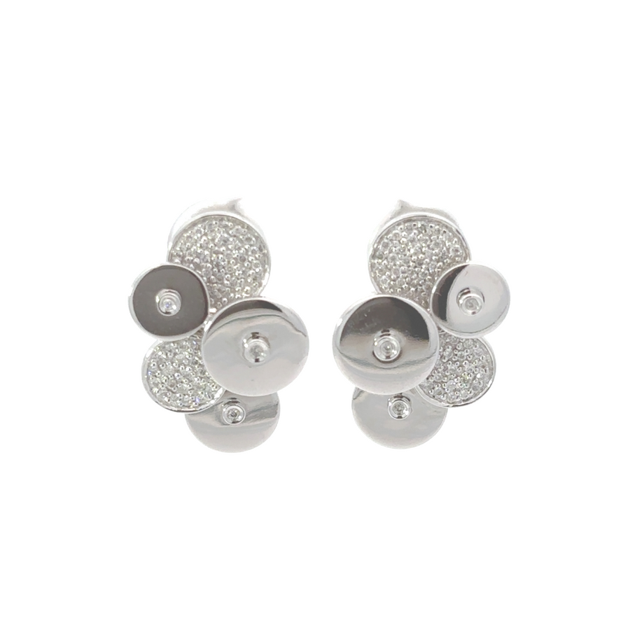 Close-up of matching gold ring and earrings with diamonds