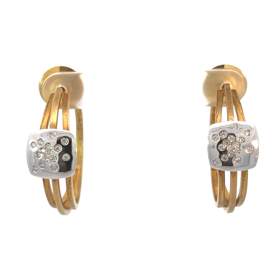 Close-up of two-tone 18k gold earrings with sparkling diamonds