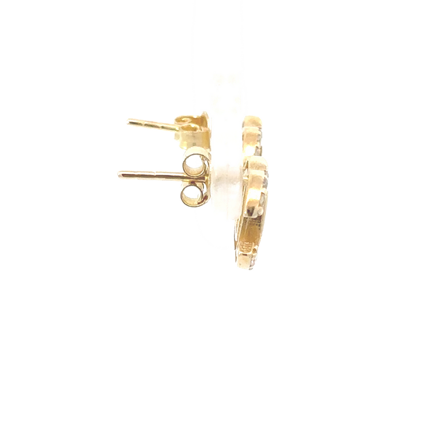 Woman wearing gold earrings with shimmering CZ accents