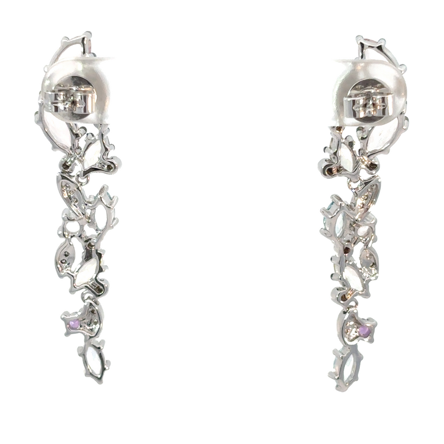 Woman wearing colorful stone earrings with radiant 14k gold setting