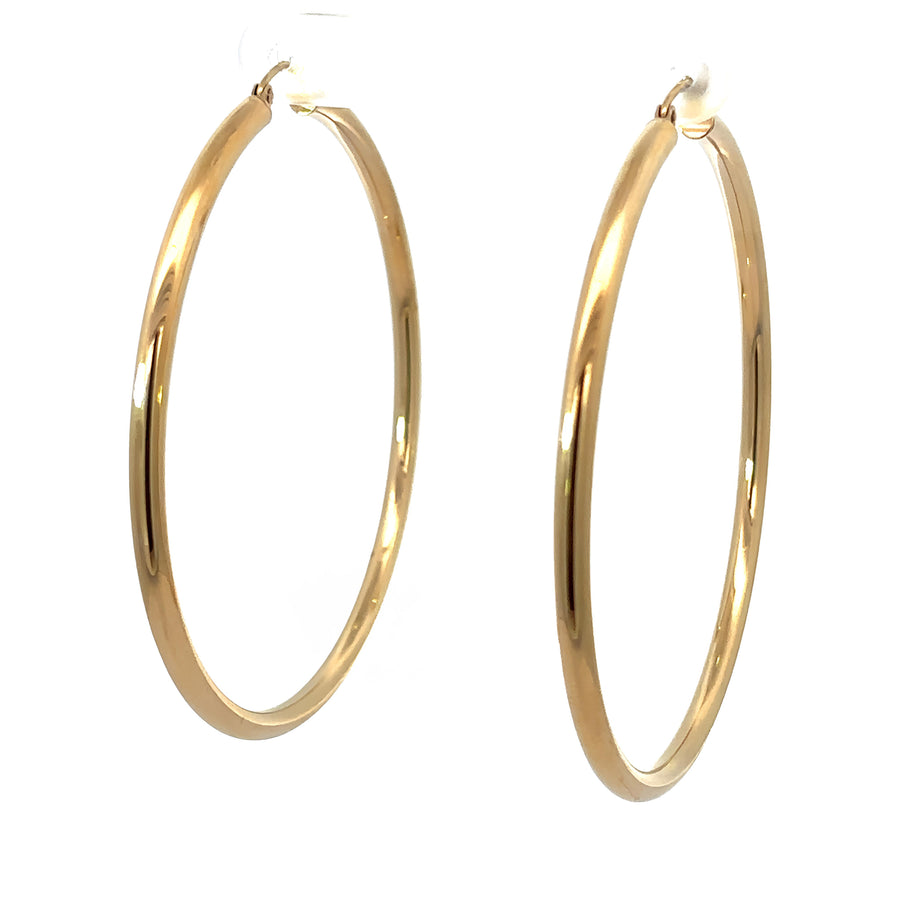 Close-up of polished 14k gold large hoop earrings for women