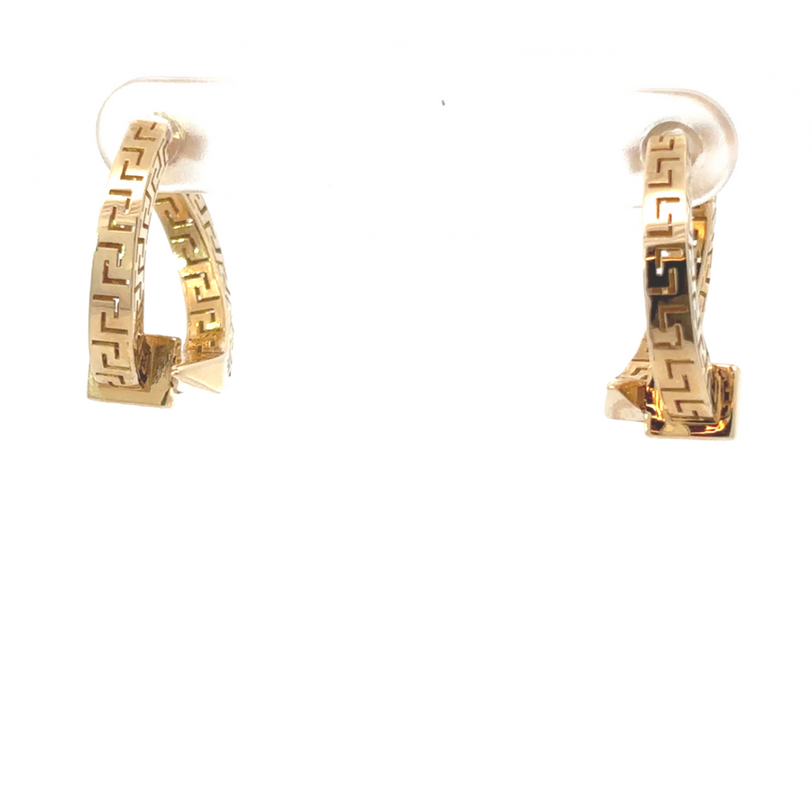 Elegant 14k gold earrings worn by a woman with a sophisticated outfit