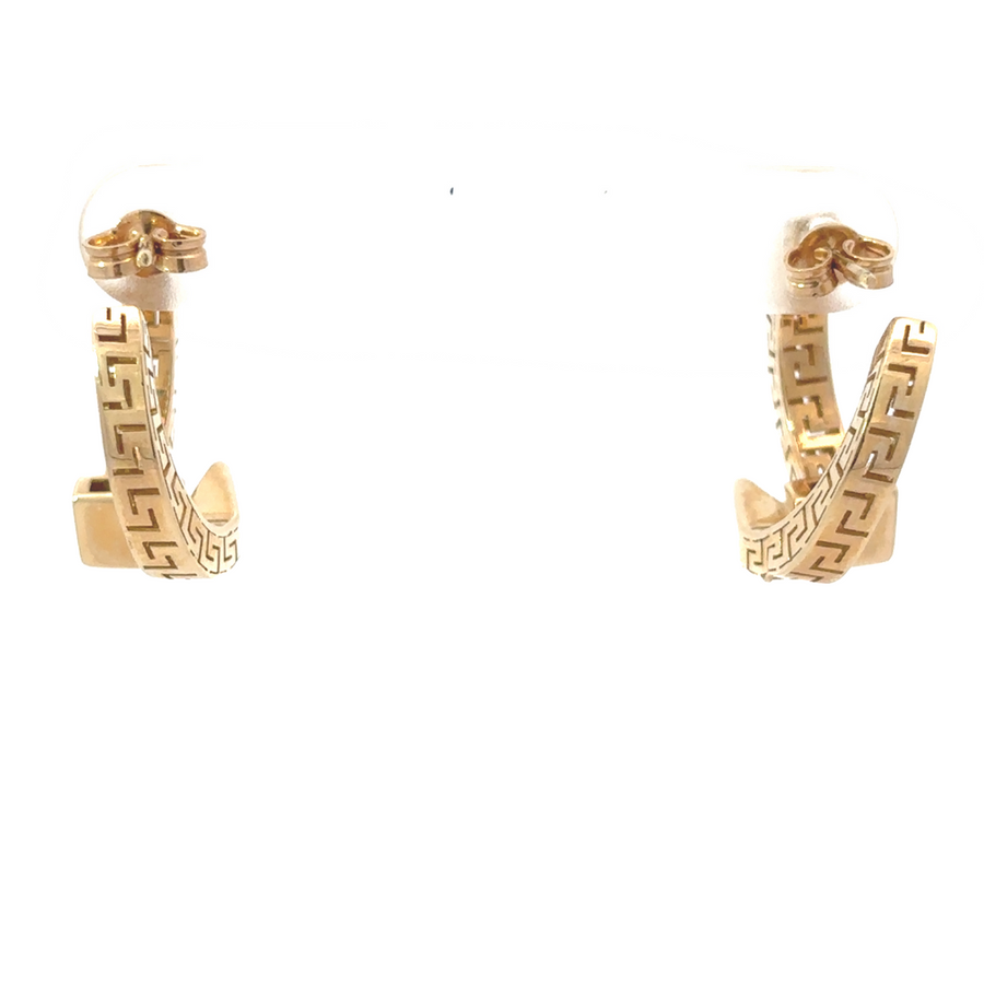 Flat-lay of 14k gold earrings placed on a marble surface for an elegant display