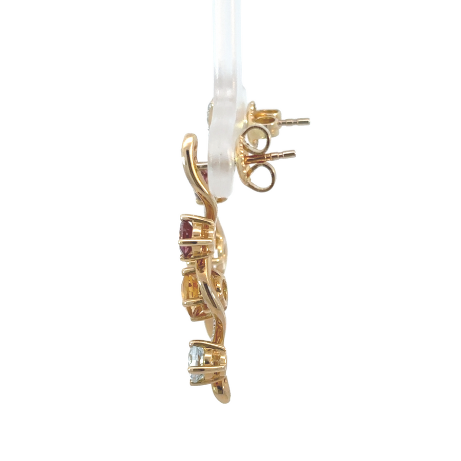 Close-up of 14k gold earrings featuring diamonds