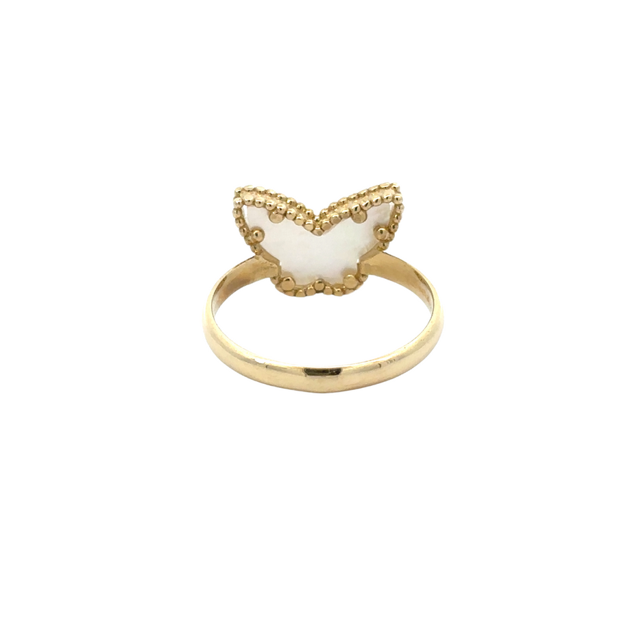 Soft-focus shot of entire gold jewelry set styled on vanity table