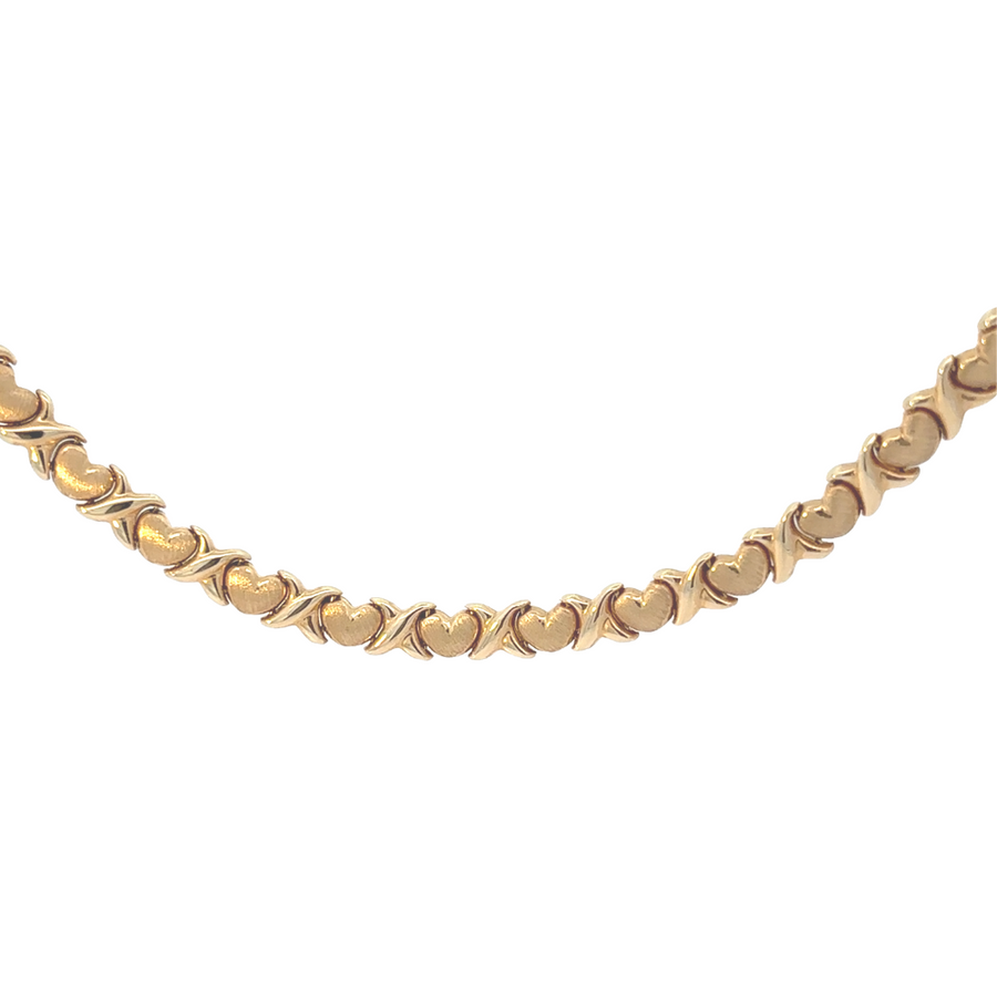 14k gold necklace draped over a jewelry stand