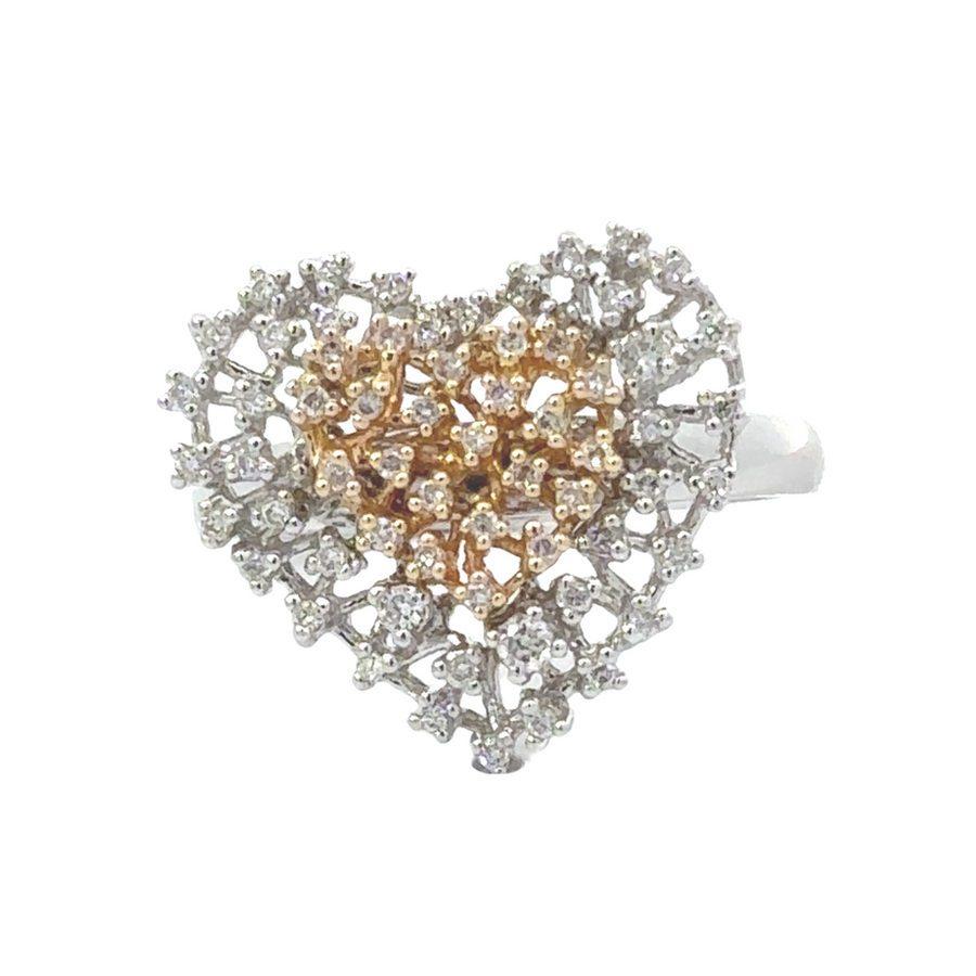 Close-up of heart-shaped gold ring in two tones