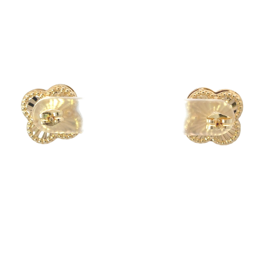 Woman wearing gold earrings with business attire