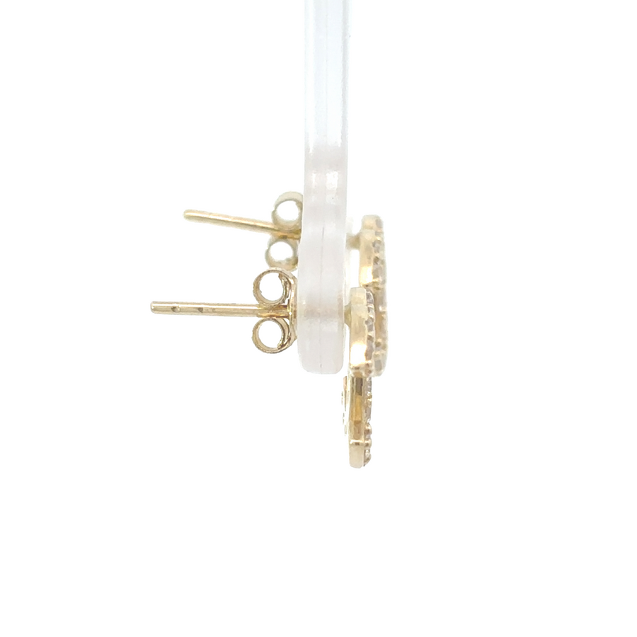 Woman wearing sparkling 14k gold earrings with cubic zirconia stones
