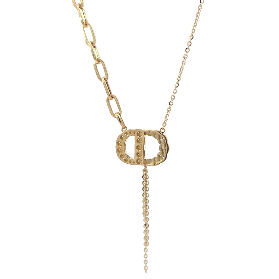 Woman wearing the 14k gold necklace with CZ, showcasing its elegant design paired with a formal outfit