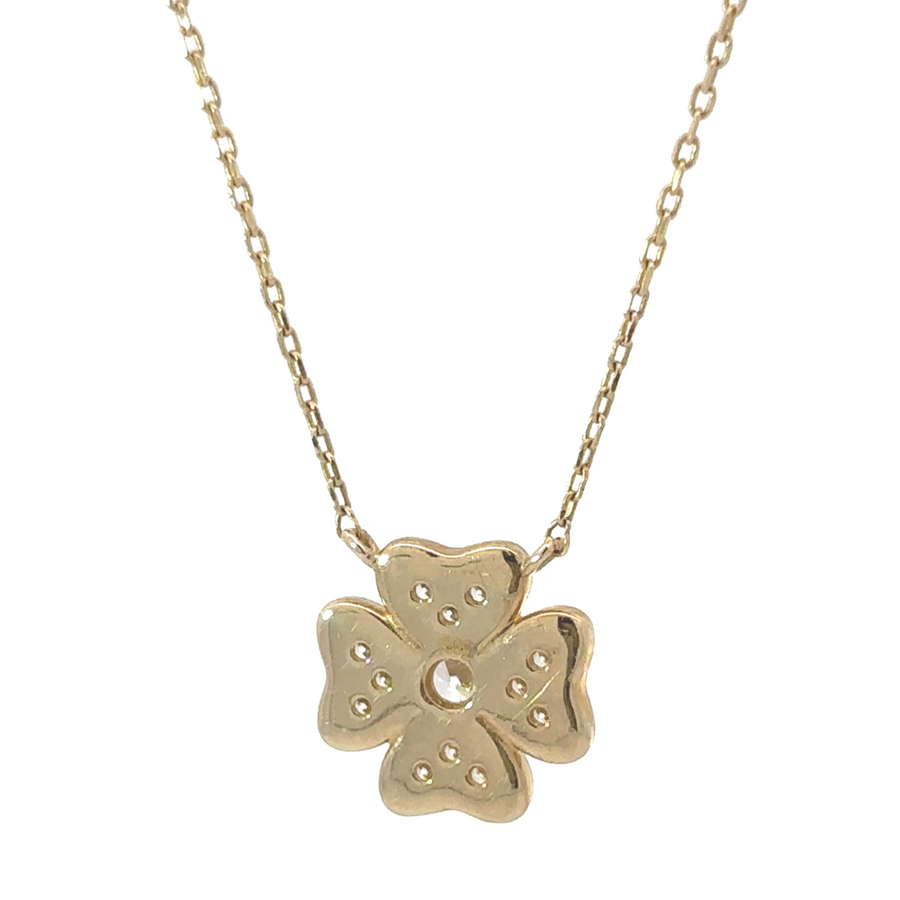 Model wearing the 14k gold necklace with center flower and CZ, highlighting its elegant design and adjustable length.