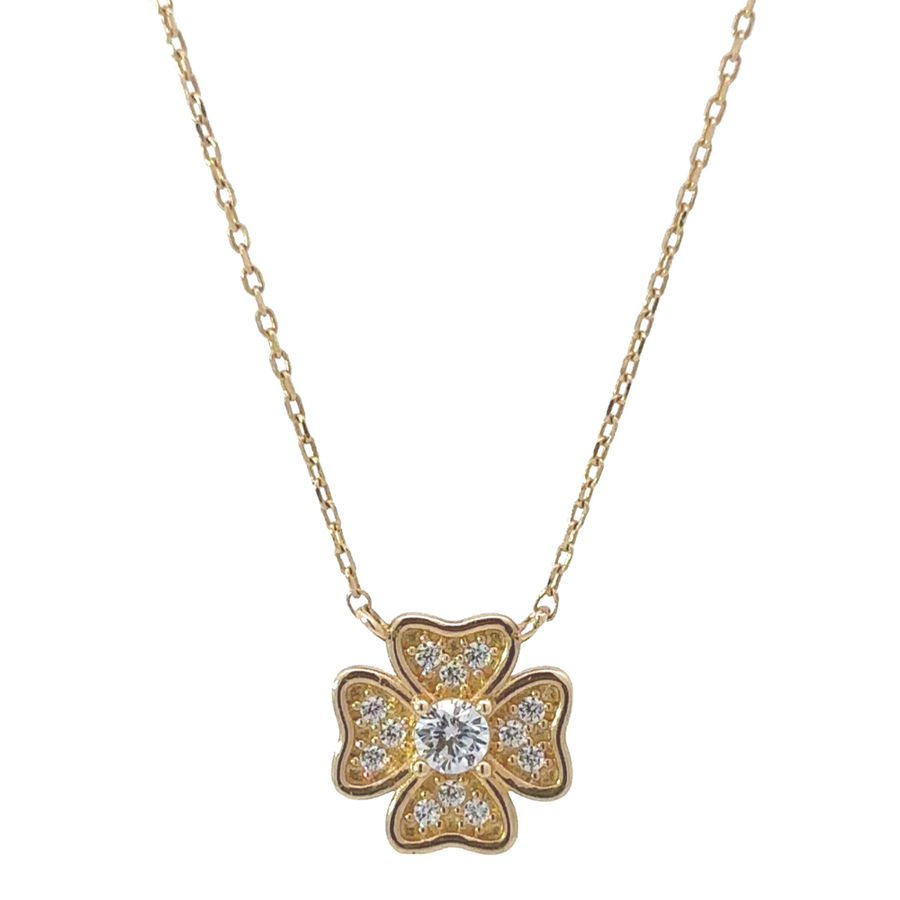 Close-up of 14k gold necklace with center flower design, adorned with sparkling cubic zirconia (CZ) stones.