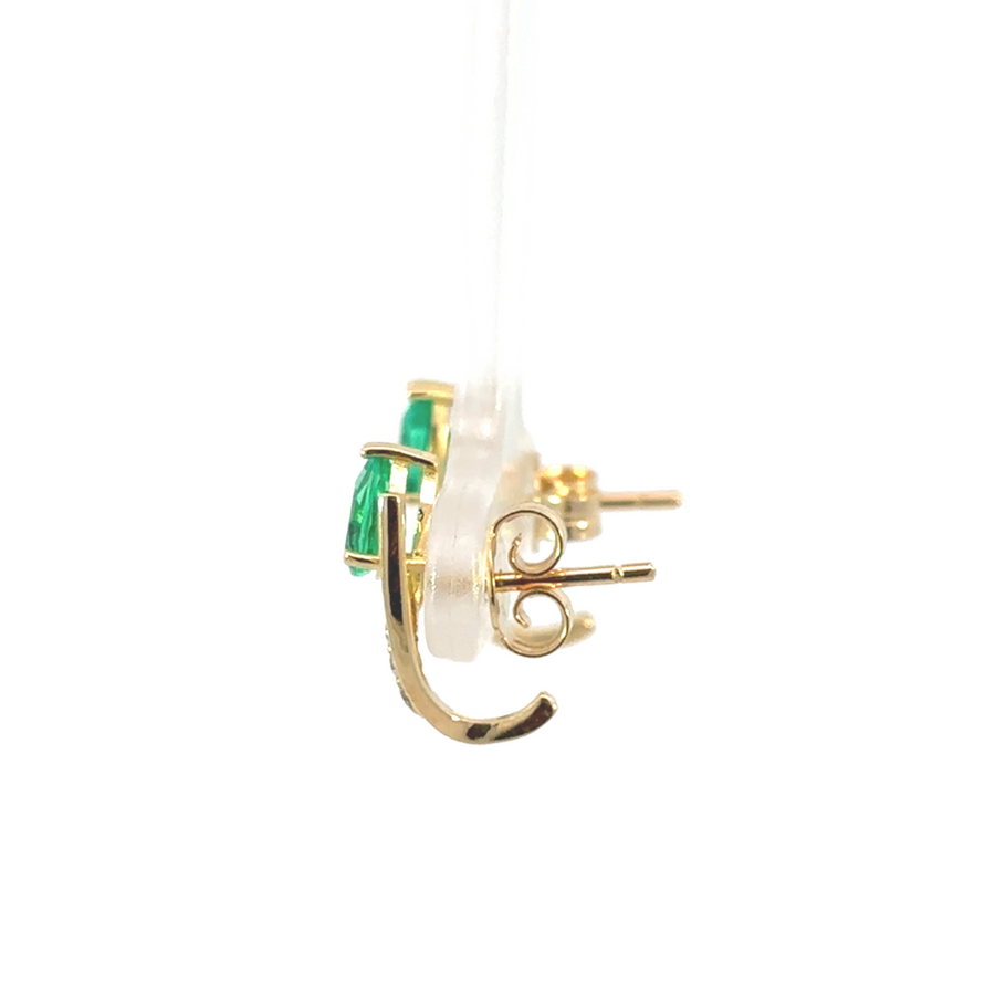 Elegant women’s emerald earrings on white background