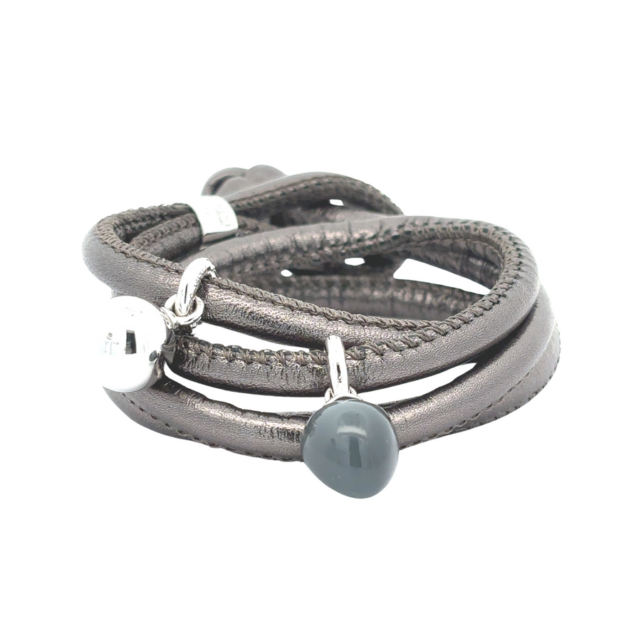 Unisex leather bracelet with 14K gold accents on display