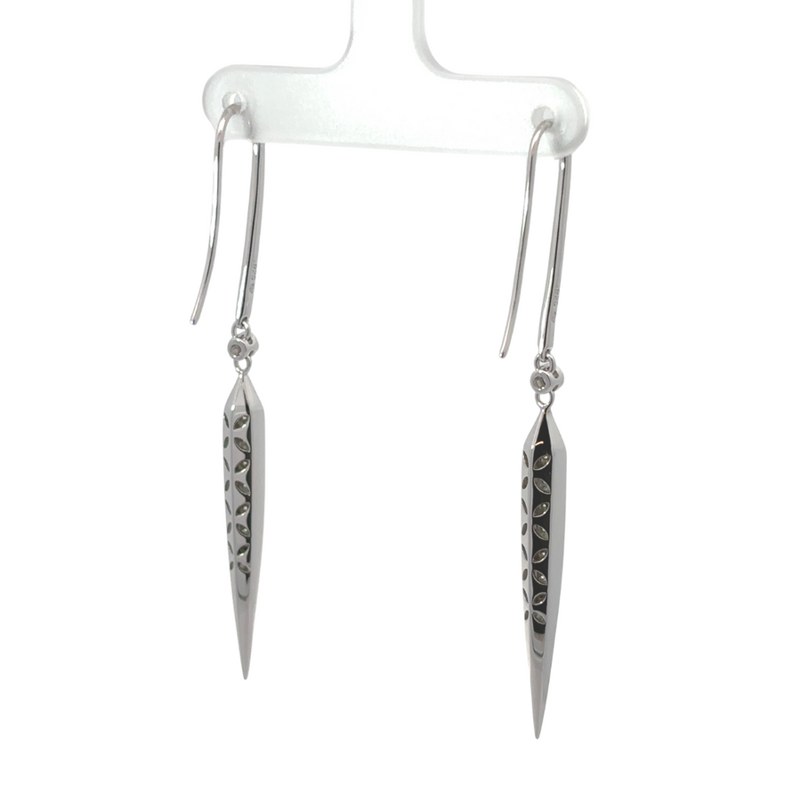 Pair of polished long silver earrings on white background