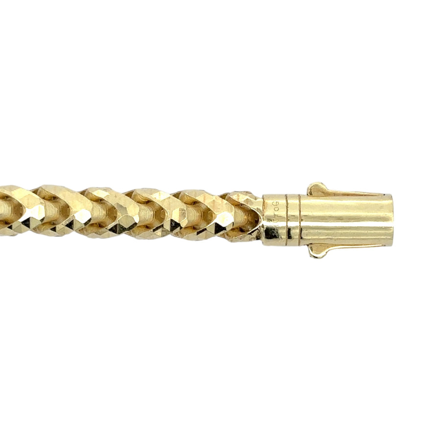 Male model wearing sleek 14k gold bracelet