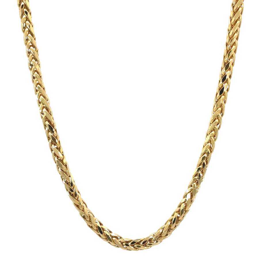 Elegant 14k gold snake chain necklace laid flat on a dark surface
