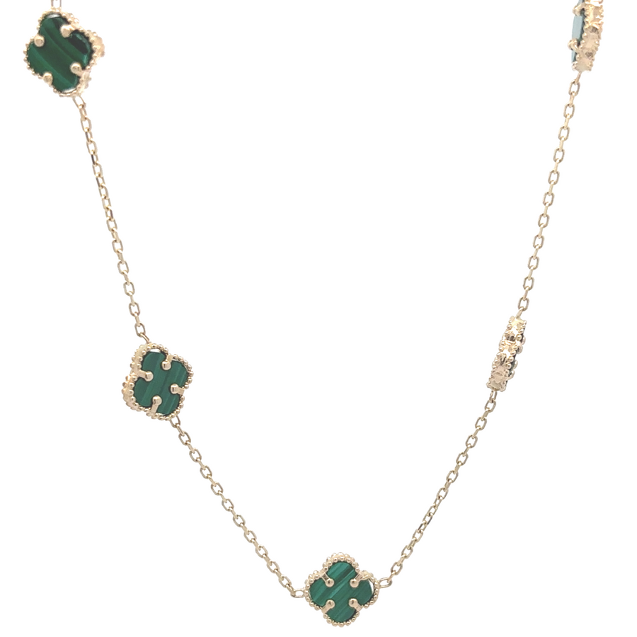 14k gold necklace with ten small green accents, highlighting the intricate craftsmanship.