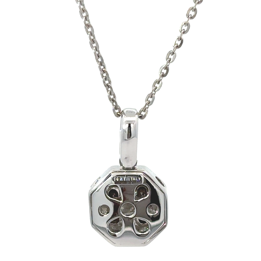 Small white gold pendant displayed without chain