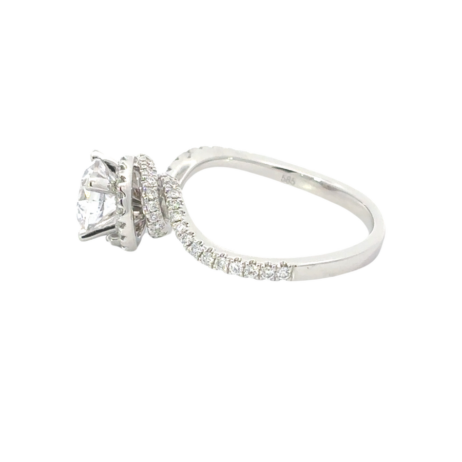 Close-up of diamond and CZ gold ring on white background