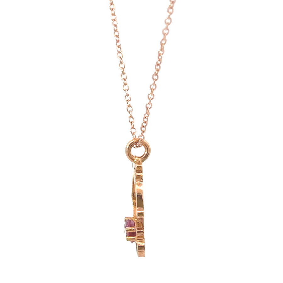 Rose gold chain with pendant on display stand