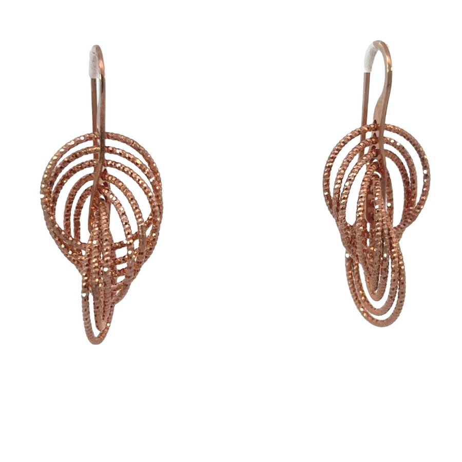 Pair of rose gold earrings for women on white background