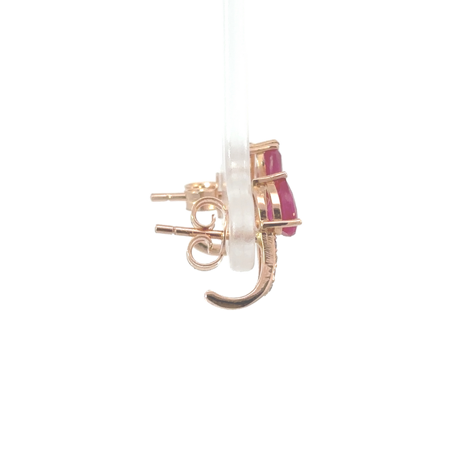 close-up of ruby earrings in pink gold