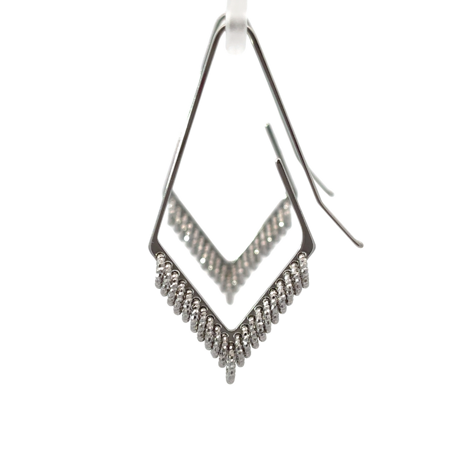Close-up of elegant silver earrings on white background